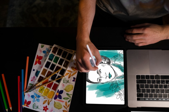 artist drawing doujen moe style character with tablet and stylus showing sketch linework and soft shading process