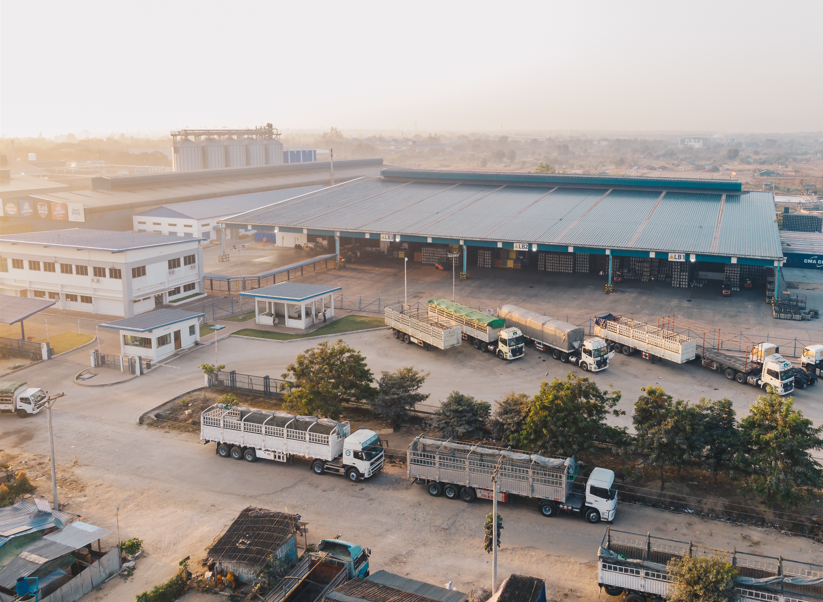 Modern private freight terminal with cargo containers, loading trucks, and warehouse operations